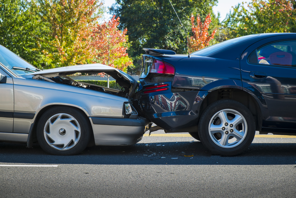 Auto accident involving two cars on a city street in need of a car accident lawyer