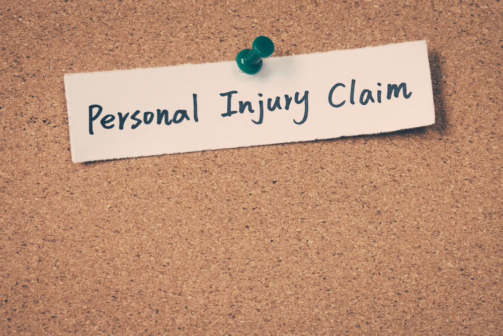 Personal Injury Claim sign pinned to the board in an attorney office